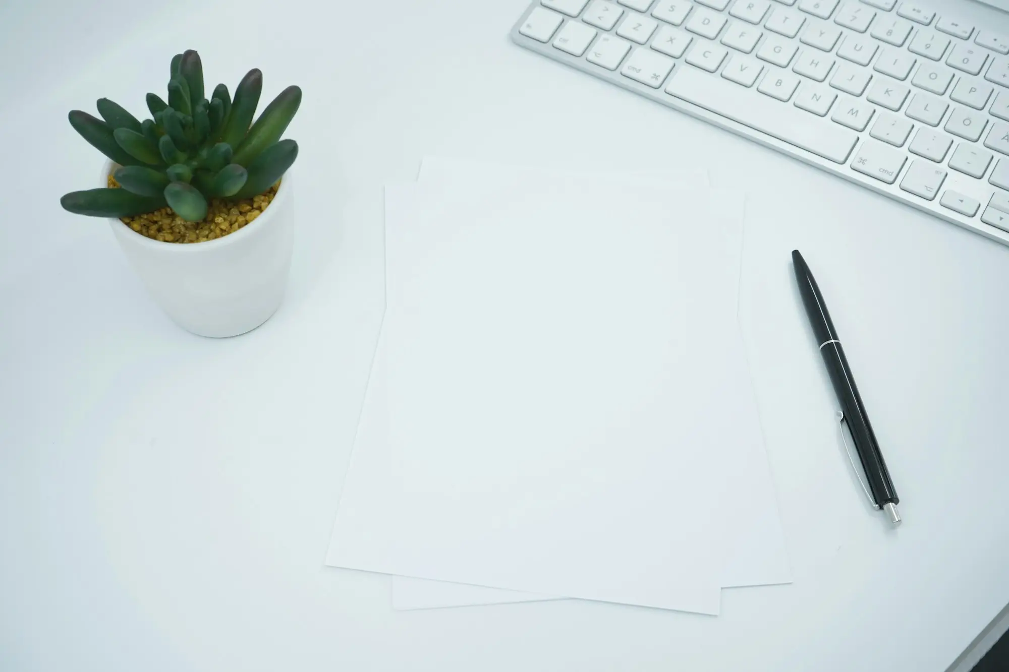 Clean desk with a pen and keyboard ready for reading loan documents